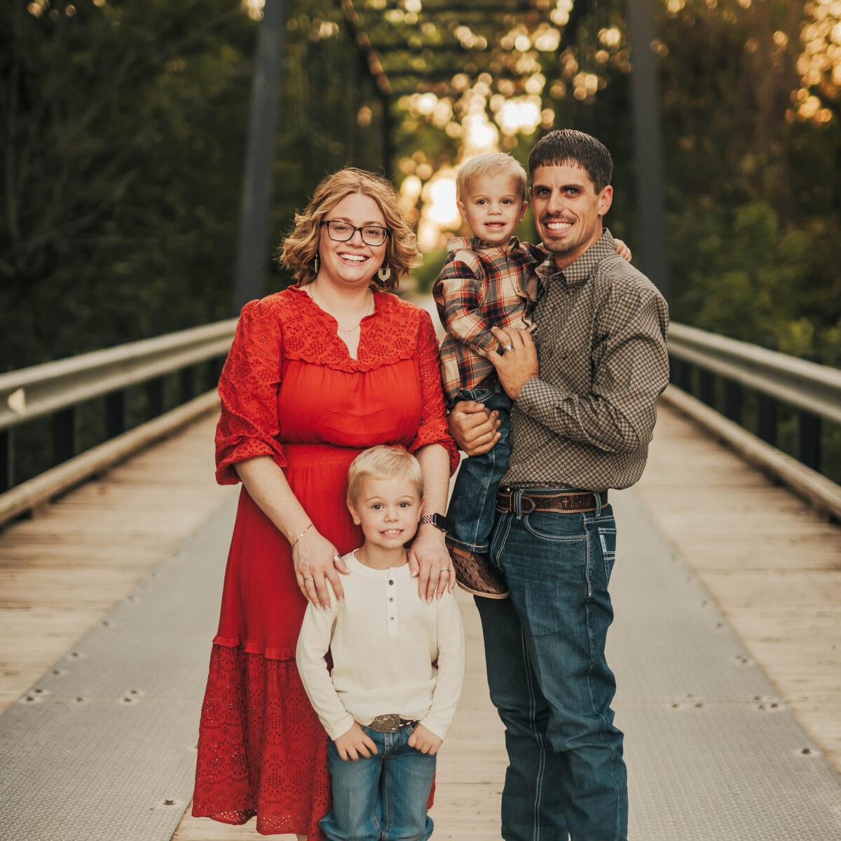 Colton and Ashley Rosenkranz with their two boys on a steel bridge outside Bryan, Texas